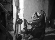 A worker at a spinning wheel, Penmachno Woollen...