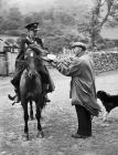 The postman arrives at Cwm Berwyn where he is...