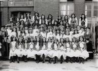 Group of girls in floral head-dresses,...