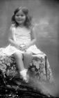 Portrait photograph of a young girl seated, c...