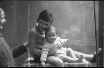 Portrait photograph of two children seated, c...