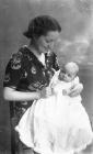 Portrait photograph of a mother and child, c193...