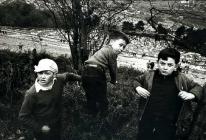 Three boys look down at the Aberfan Cemetery in...