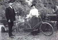 Unknown man and a woman with a bike