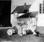 Photograph of Child on toy horse and cart, 1959