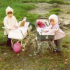 Two girls playing with prams