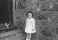 Little girl outside house