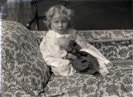 Portrait of a very young child sitting on a...