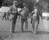 Three gentlemen pose at an agricultural show in...