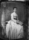 young woman sitting and holding a book