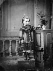 young girl standing on a trunk