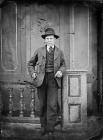 young man standing and wearing a hat