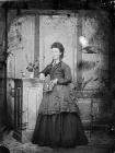 young woman standing and holding a book