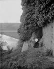 A lady sitting in front of ruins 