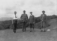 Four gentlemen golfer on the tee of a golf course
