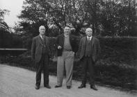 Tree men standing on a road