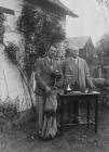 Two men standing behind a table holding a trophy