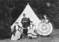 Two men and women with archery equipment, c.1910