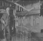 Unknown man with cupboard, circa 1930s