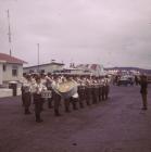 A band in uniform playing in the street