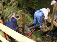 Community volunteers replacing the bridge near...