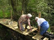 Community volunteers replacing the bridge near...