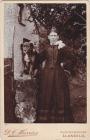 Woman in Victorian costume, with dog. DC...