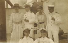 Group of men and women on an unidentified ship ...