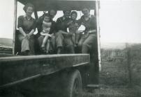A group of Land Army women with children