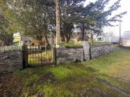 Churchyard gateway and churchyard wall to right...