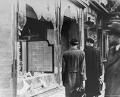 Photograph of the broken shop windows of a...