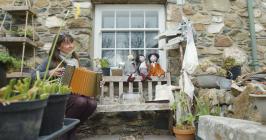 Hedydd Hughes playing accordeon outside her...