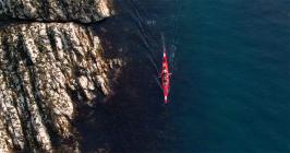 Aerial view of Eila Wilkinson passing by rocky...