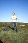 Cas Eikenaar with gull chick, Skomer Island, 2001.