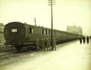 Four troops posed outside train