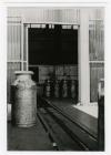 Milk churns in unloading bay, Felin Fach Creamery