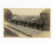 Postcard image of a wagon drawn by horses...